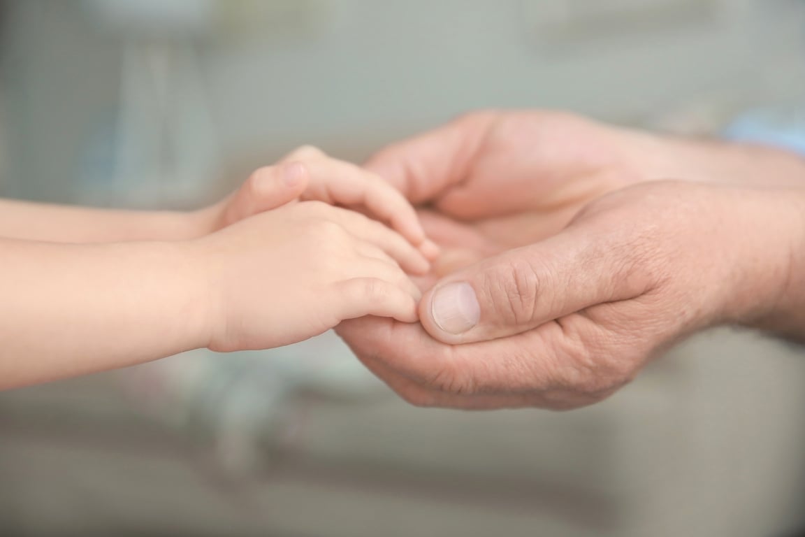 Senior Man and Little Child Holding Hands